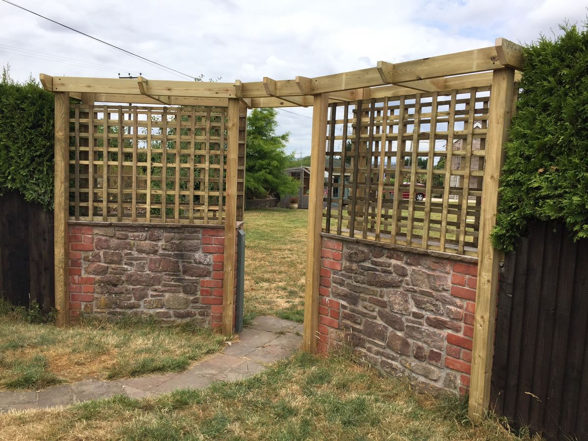 Pergola and trellis screens framing a garden walkway