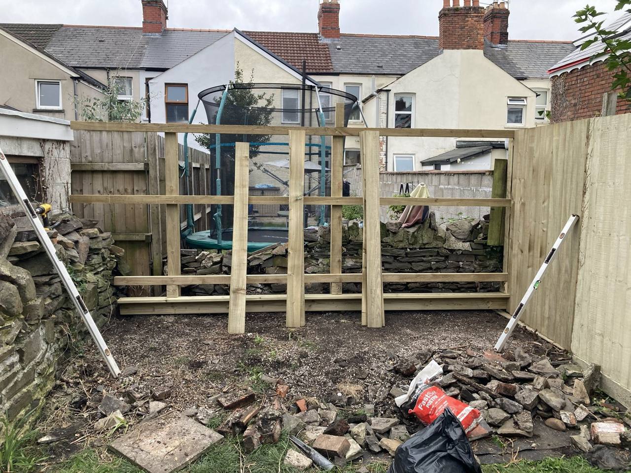 Horizontal rails fixed between the new fence posts